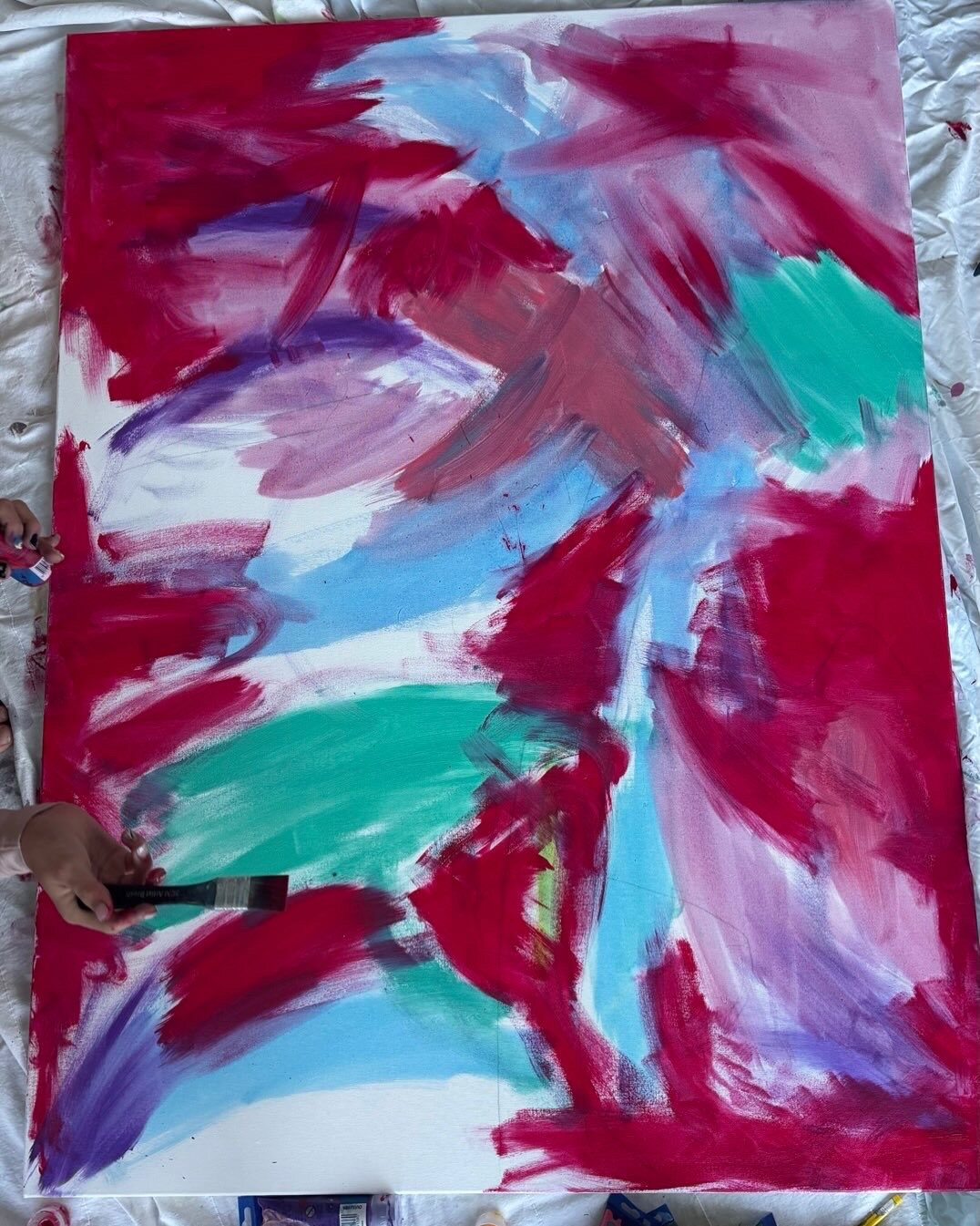 A colourful painting in progress in the studio